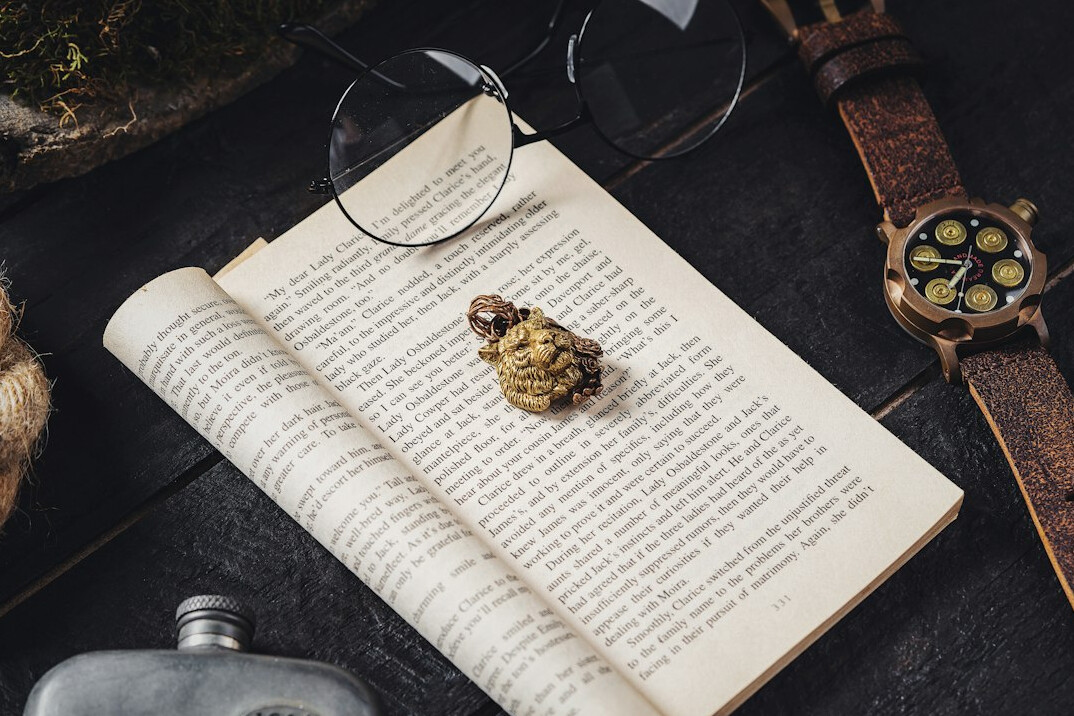 Antique magnifying glass resting on an open book page