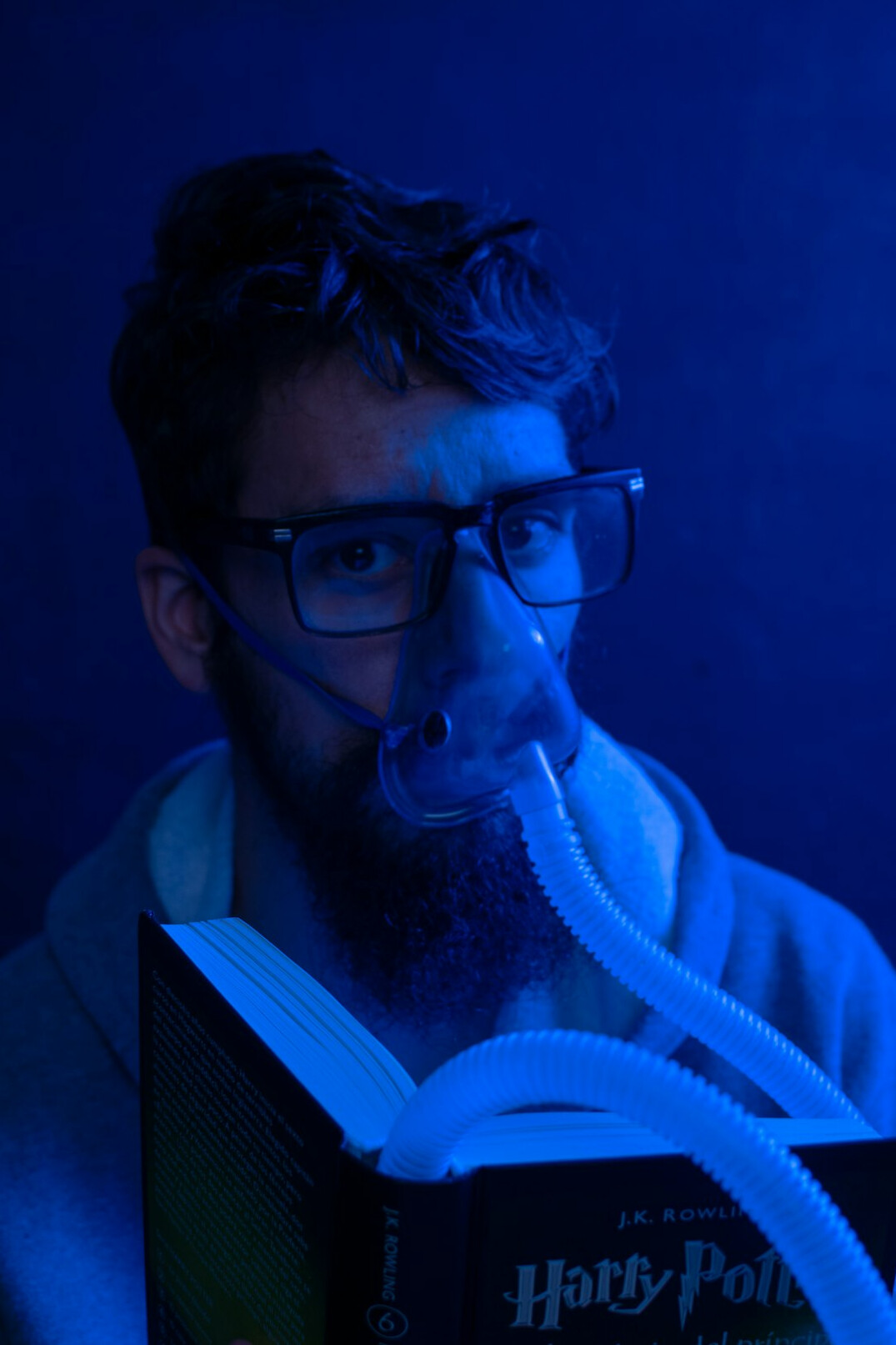 Studio portrait of a Hispanic man writer with glasses