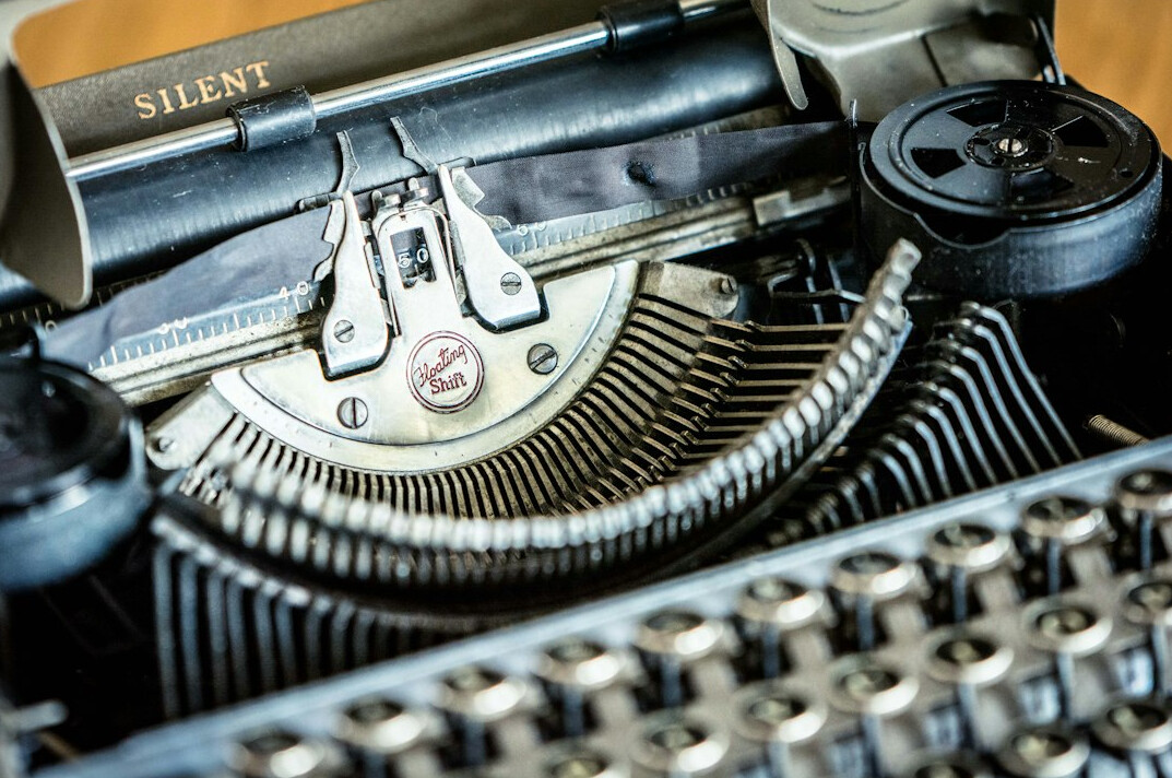Close-up of a vintage typewriter with a sheet of paper